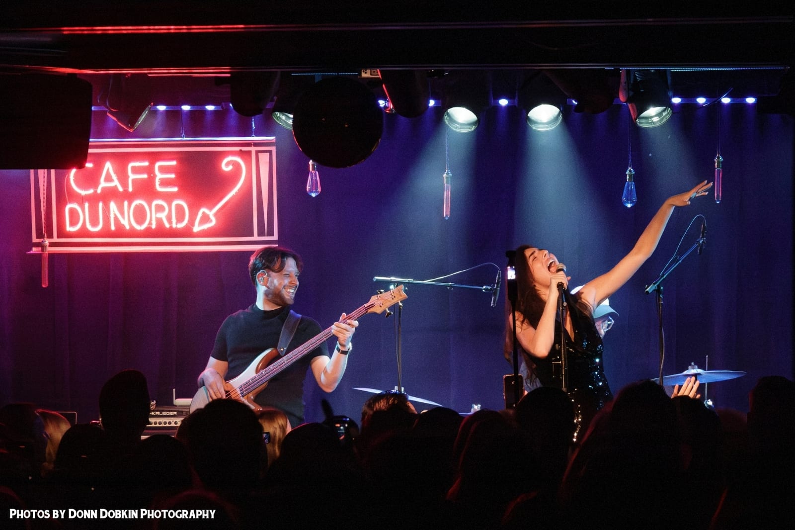A band on the stage in blue and purple light
